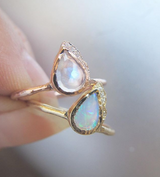 Two Raindrop Moonstone Rings with White Round Brilliant Diamonds on Woman's Fingers.