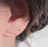 Branch Ear Crawler with White round brilliant diamonds on woman's ear.