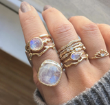 Moonstone Yellow Gold Rings on woman's right hand.