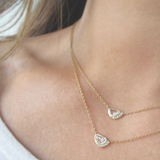 2 Gold Half Moon Bay Necklace on woman's neck.