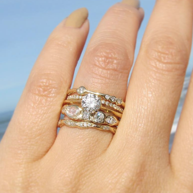 5 Diamond Rings on woman's hand.