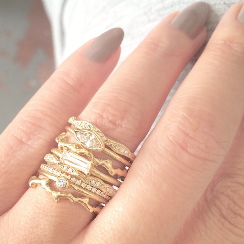 Yellow gold rings on woman's hand.