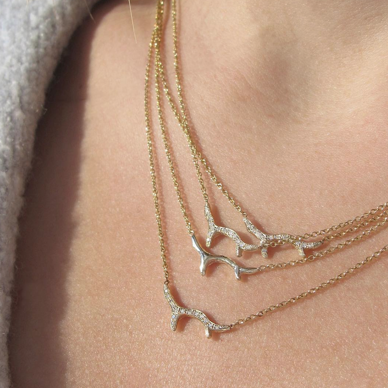 4 14k Yellow gold Branch Necklaces on woman's neck.