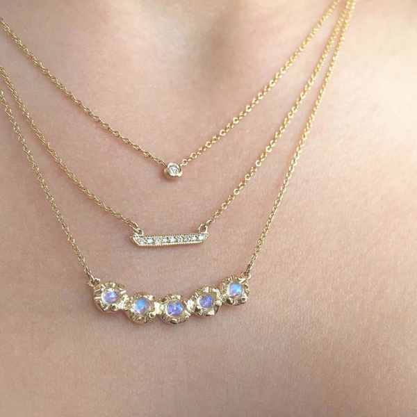 14k Yellow gold Stardust Floating Diamond Necklace on woman's neck.