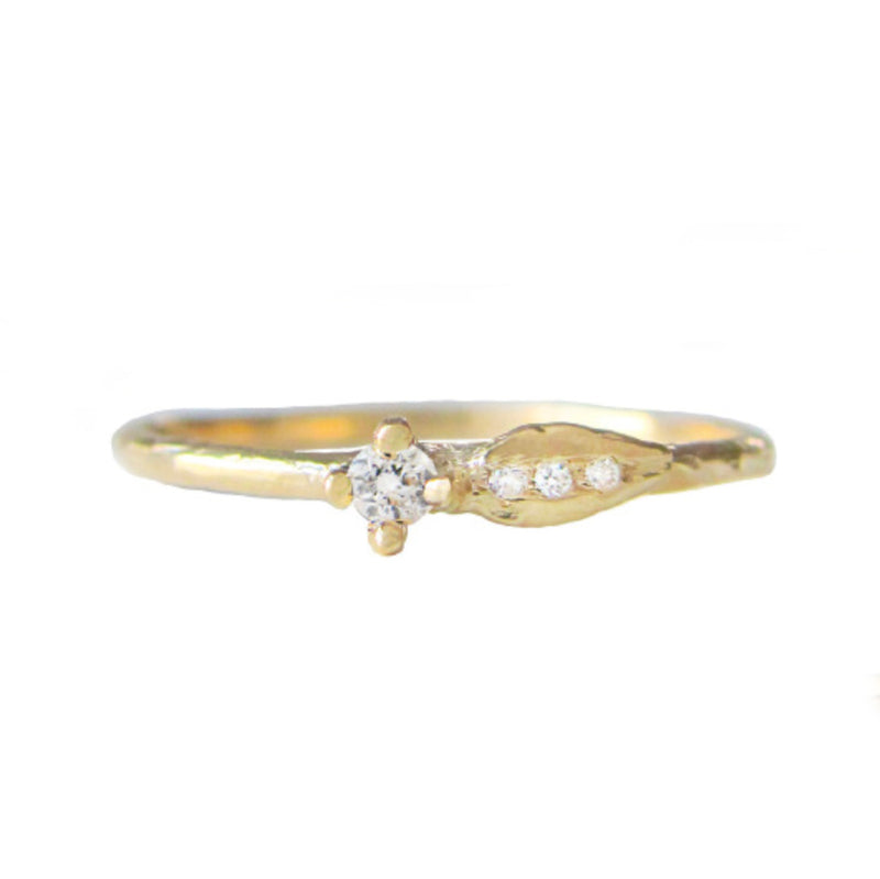 Sprout diamond ring with three white round brilliant accent diamonds.