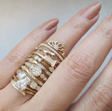 Gold Rings with diamonds on woman's hand.