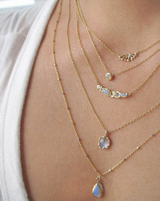 14K Superstar Necklace on Woman's Neck as Part or a Larger Collection.