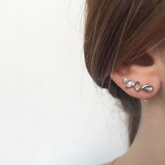 set of Water Lily gold Earrings on woman's ear. 